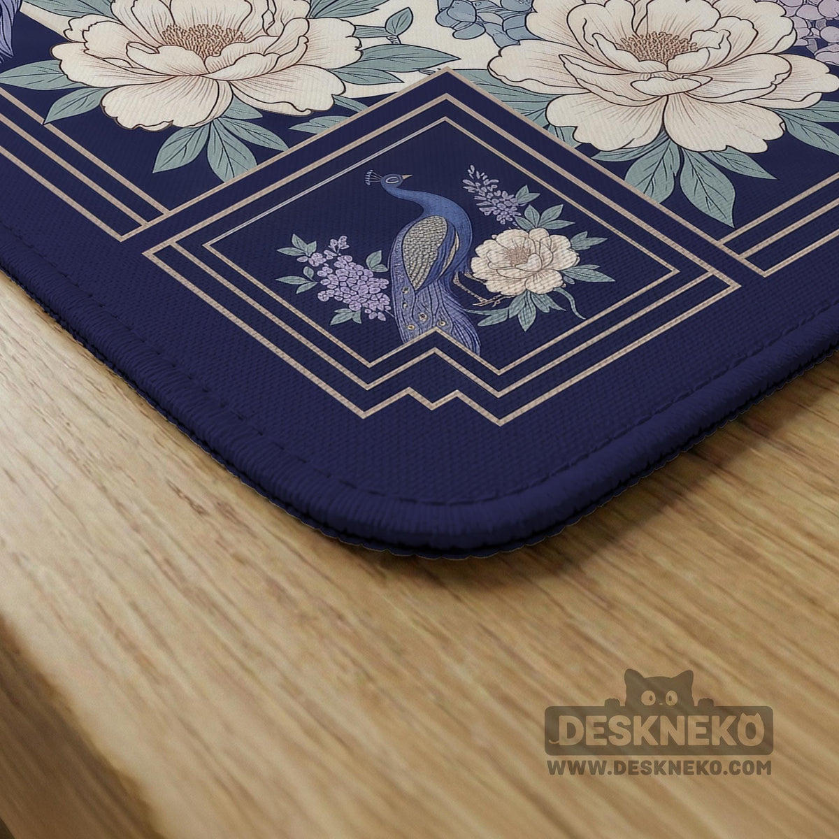Blue mahjong mat with a floral peacock border and an open center area for tile play.