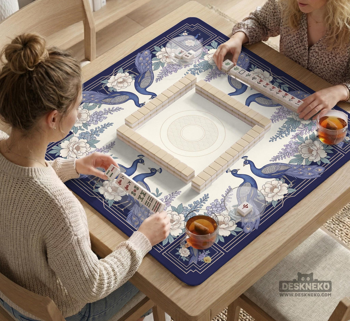 Blue mahjong mat with a floral peacock border and an open center area for tile play.