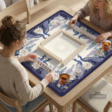 Blue mahjong mat with a floral peacock border and an open center area for tile play.