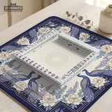 Blue mahjong table mat with a peacock and floral border, ivory center, lavender flowers, and scalloped edges.