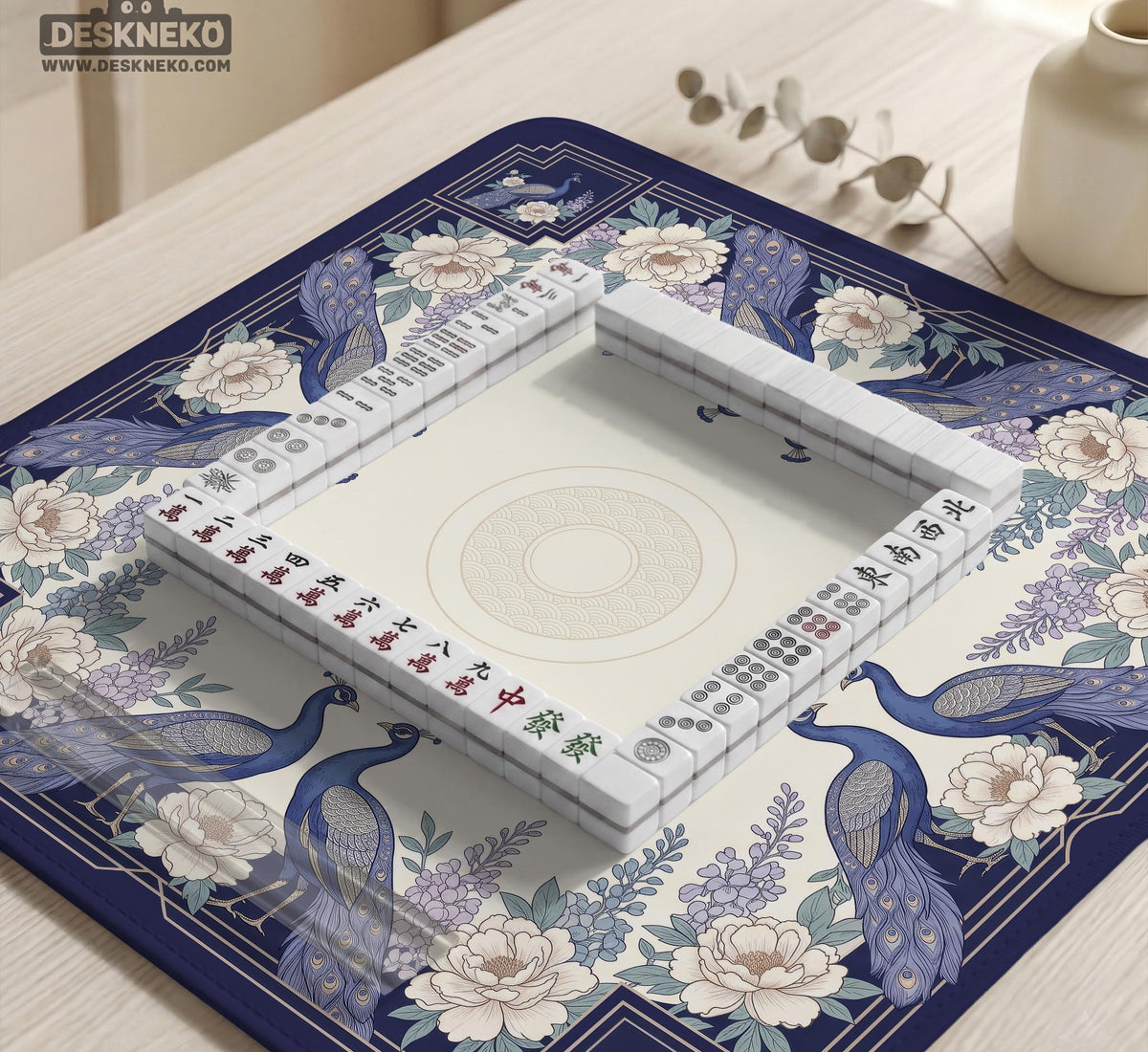 Blue mahjong mat with a floral peacock border and an open center area for tile play.