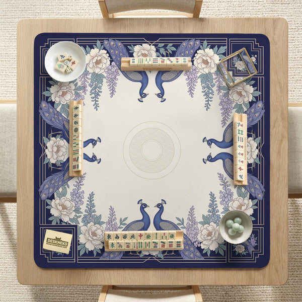 Blue mahjong table mat with a peacock and floral border, ivory center, lavender flowers, and scalloped edges.
