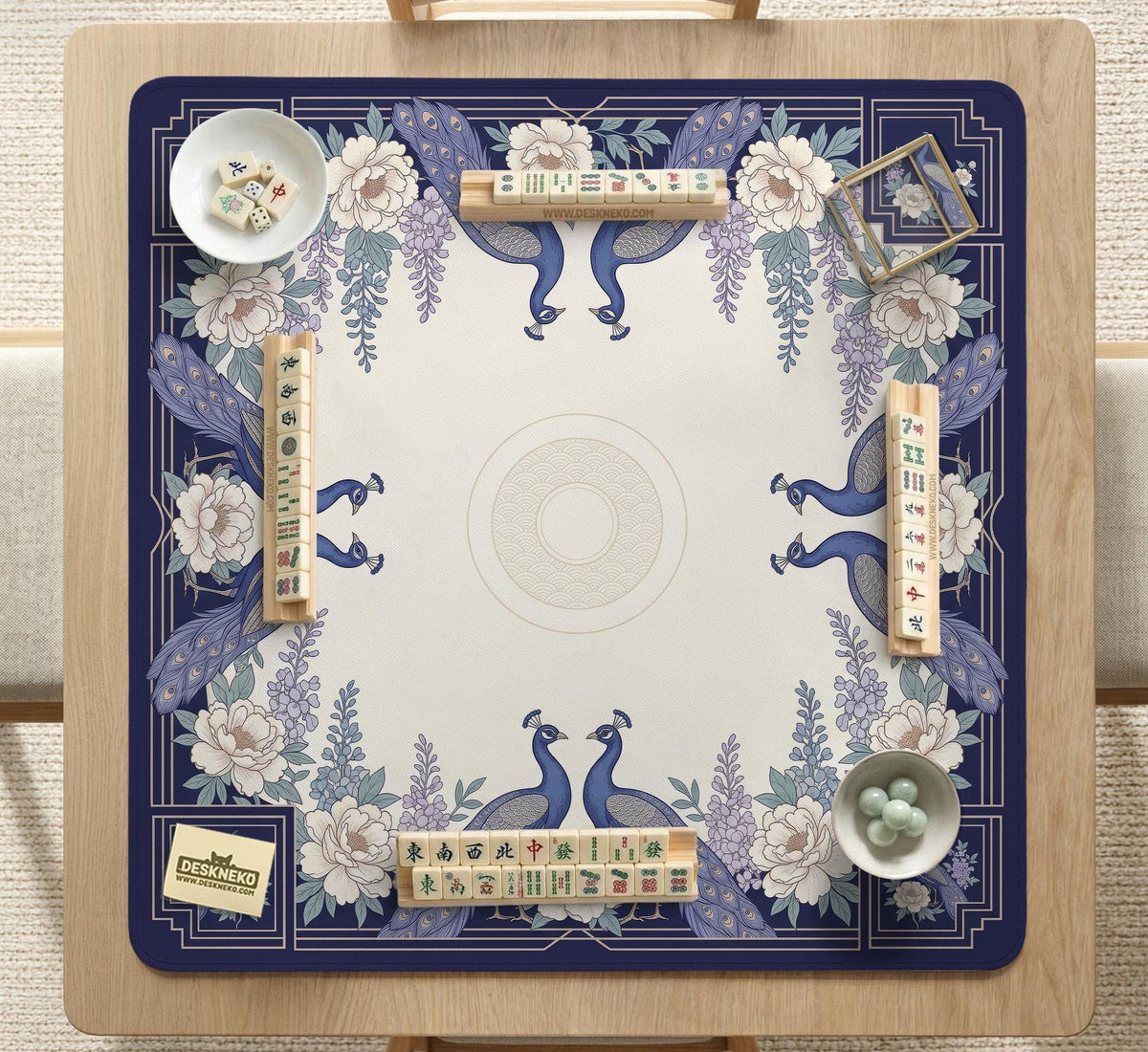 Blue mahjong mat with a floral peacock border and an open center area for tile play.