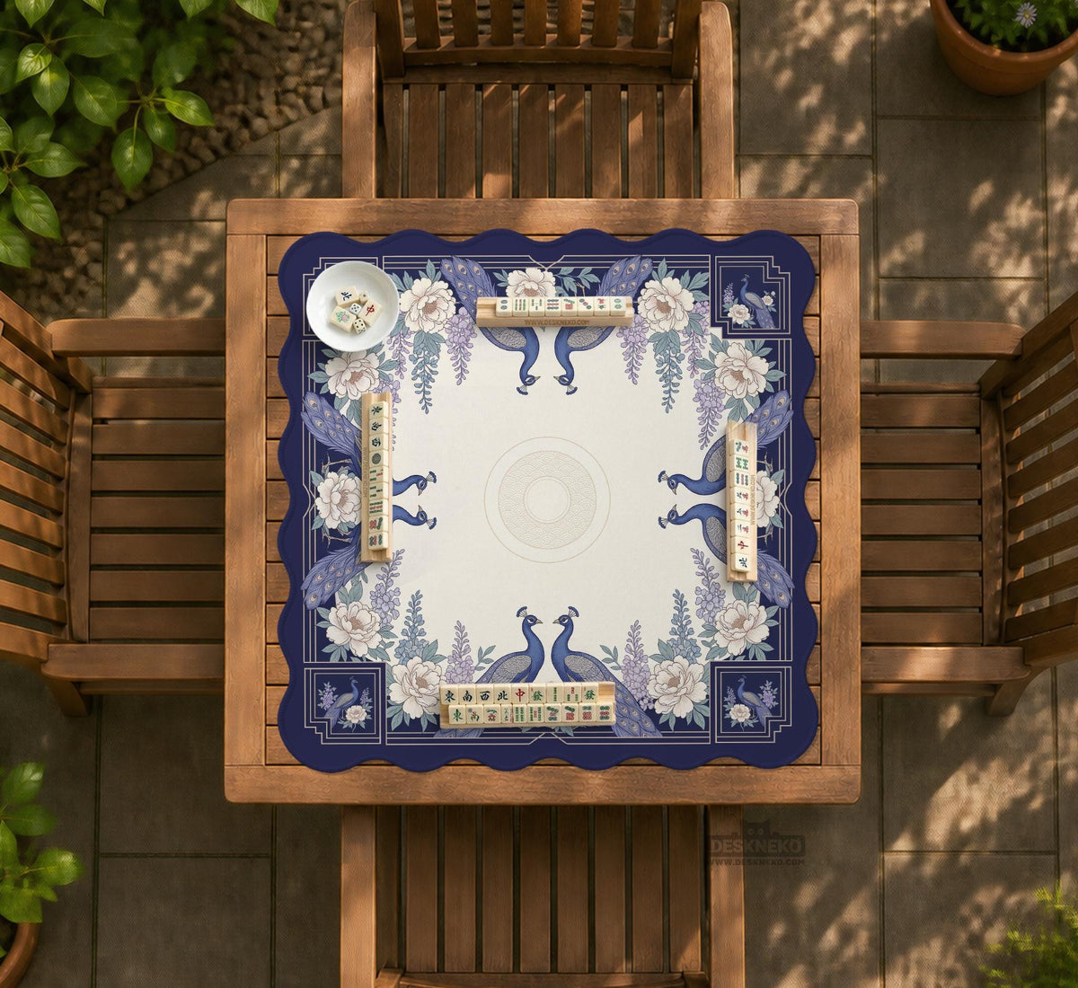 Blue mahjong mat with a floral peacock border and an open center area for tile play.