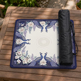Blue mahjong mat with a floral peacock border and an open center area for tile play.