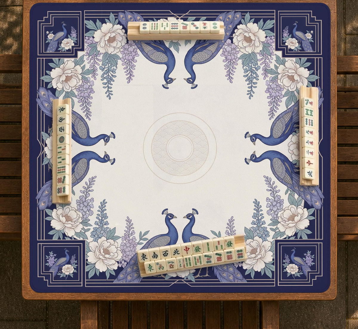 Blue mahjong mat with a floral peacock border and an open center area for tile play.