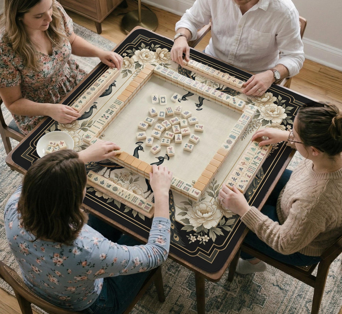 Square ivory mahjong mat with a black peacock border, cream flowers, and gold accent details.
