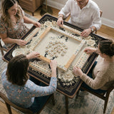 Square ivory mahjong mat with a black peacock border, cream flowers, and gold accent details.