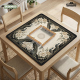 Square ivory mahjong mat with a black peacock border, cream flowers, and gold accent details.