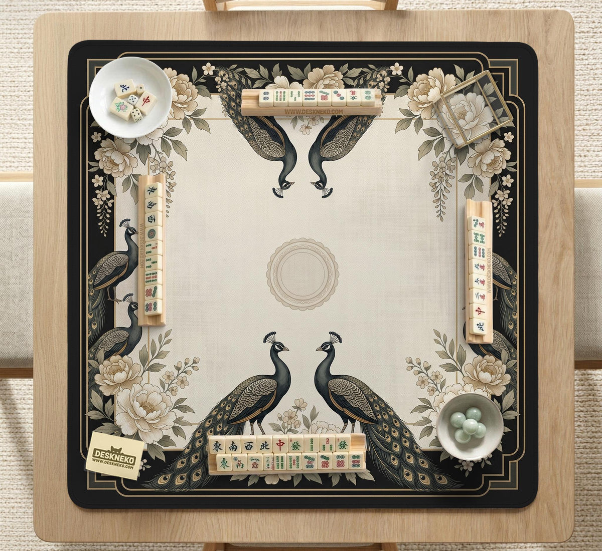 Square ivory mahjong mat with a black peacock border, cream flowers, and gold accent details.