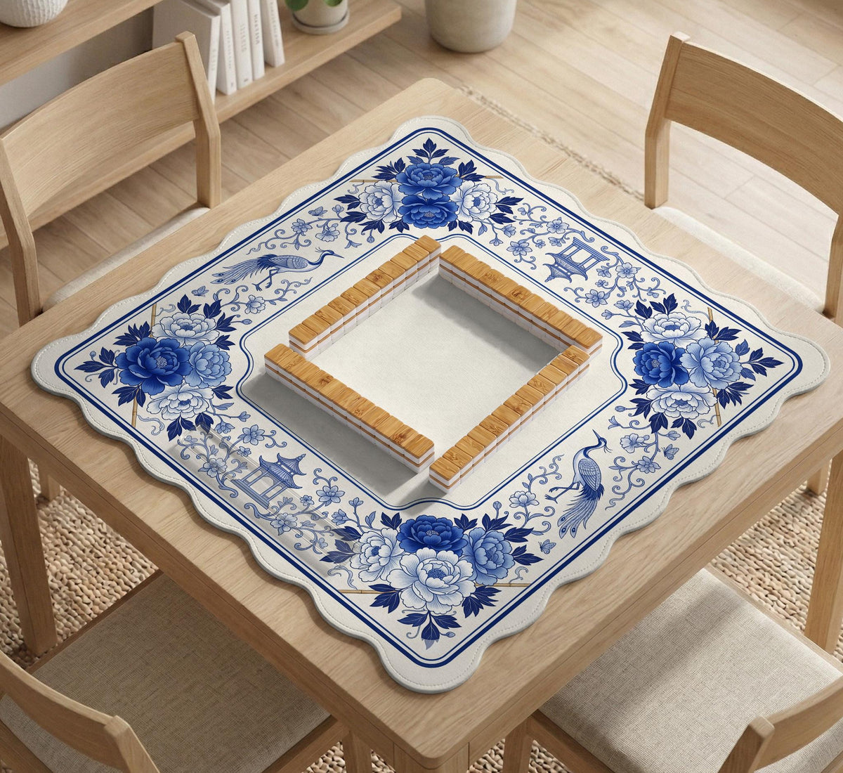 Square blue and white mahjong mat with peonies, cranes, pagoda accents, and chinoiserie linework around a plain center.