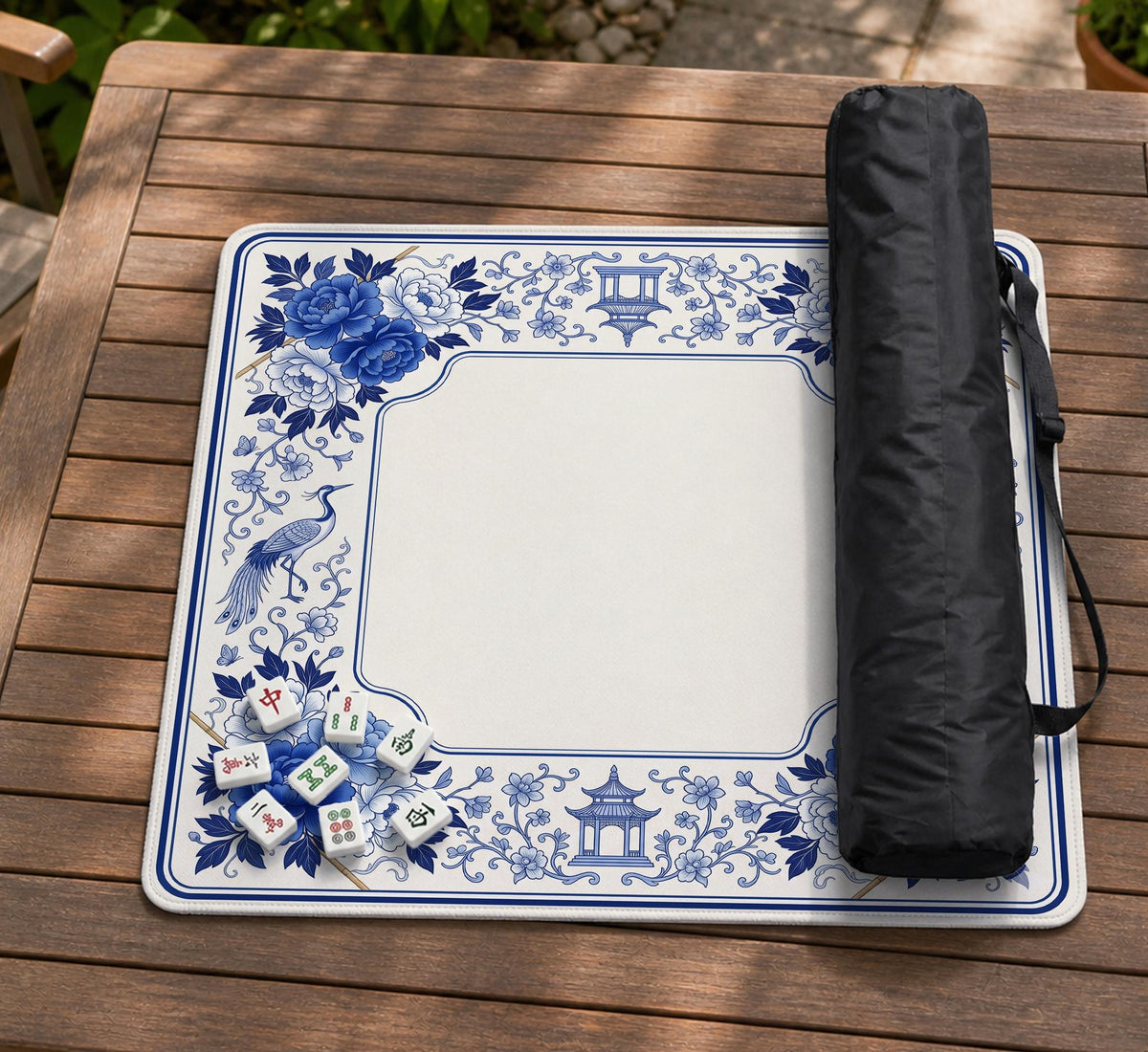 Square blue and white mahjong mat with peonies, cranes, pagoda accents, and chinoiserie linework around a plain center.