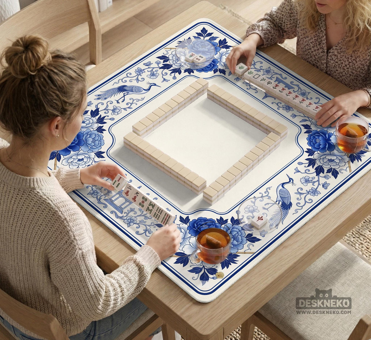 Square blue and white mahjong mat with peonies, cranes, pagoda accents, and chinoiserie linework around a plain center.