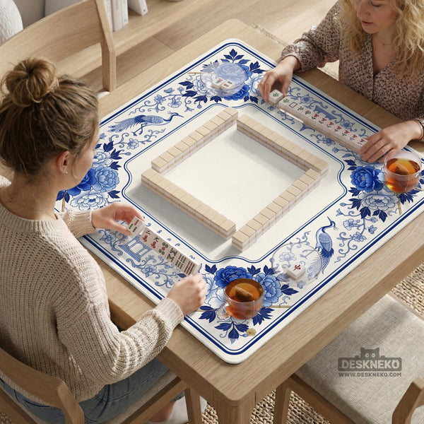 Square blue and white mahjong mat with peonies, cranes, pagoda accents, and chinoiserie linework around a plain center.