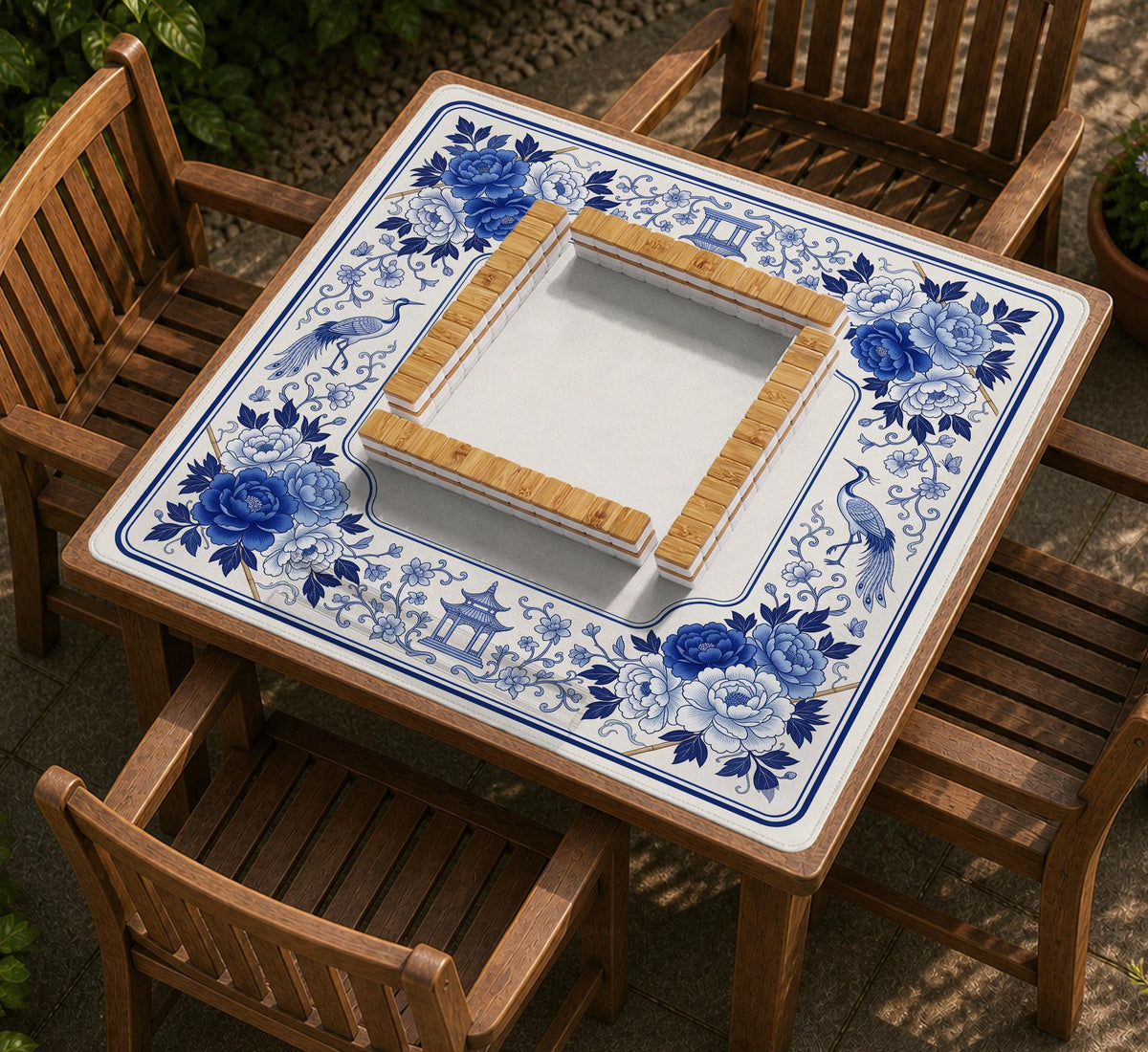 Square blue and white mahjong mat with peonies, cranes, pagoda accents, and chinoiserie linework around a plain center.