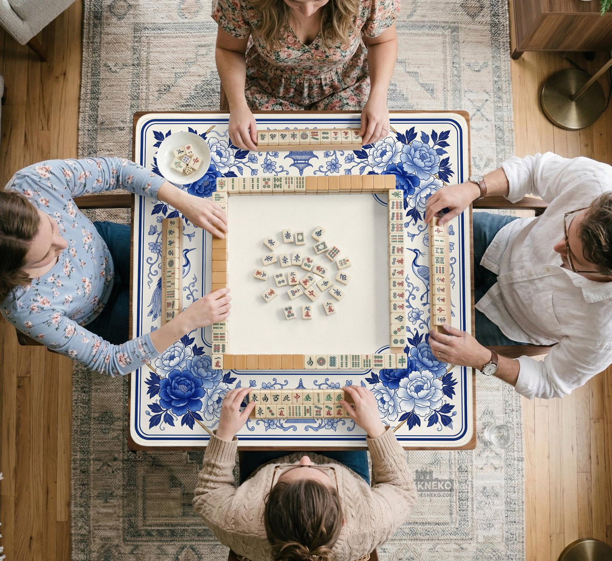 Square blue and white mahjong mat with peonies, cranes, pagoda accents, and chinoiserie linework around a plain center.