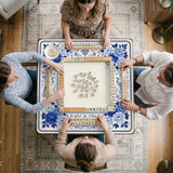 Square blue and white mahjong mat with peonies, cranes, pagoda accents, and chinoiserie linework around a plain center.