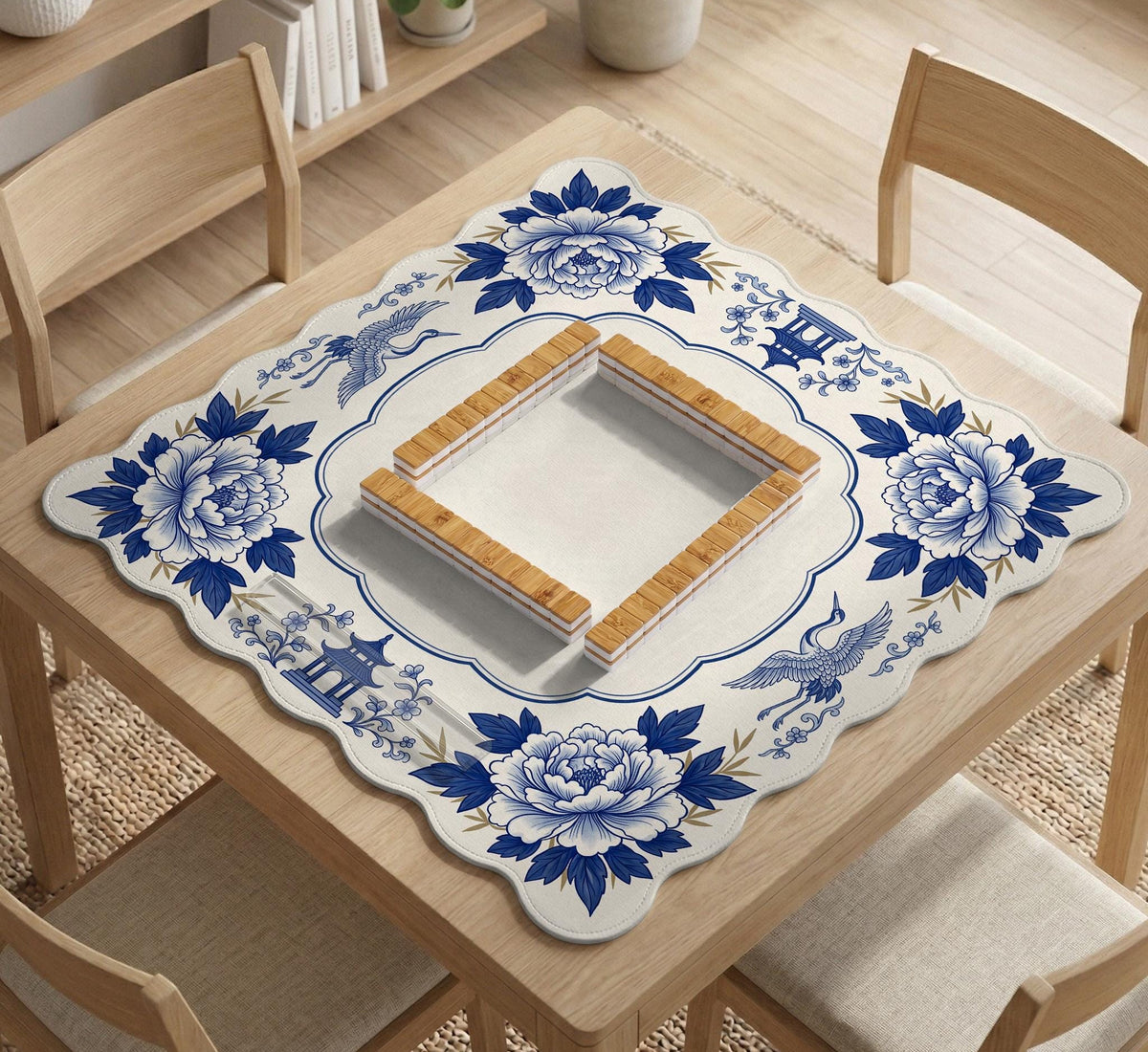 Blue and white mahjong mat with cranes, floral porcelain-style artwork, a cream center area, and a decorative border.