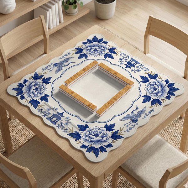 Blue and white mahjong mat with cranes, floral porcelain-style artwork, a cream center area, and a decorative border.