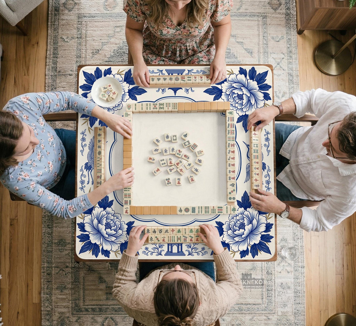 Blue and white mahjong mat with cranes, floral porcelain-style artwork, a cream center area, and a decorative border.