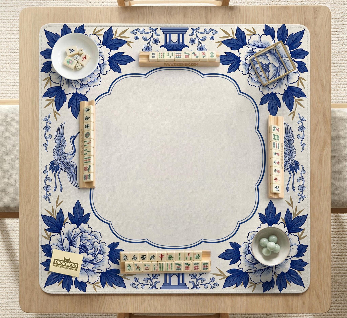 Blue and white mahjong mat with cranes, floral porcelain-style artwork, a cream center area, and a decorative border.