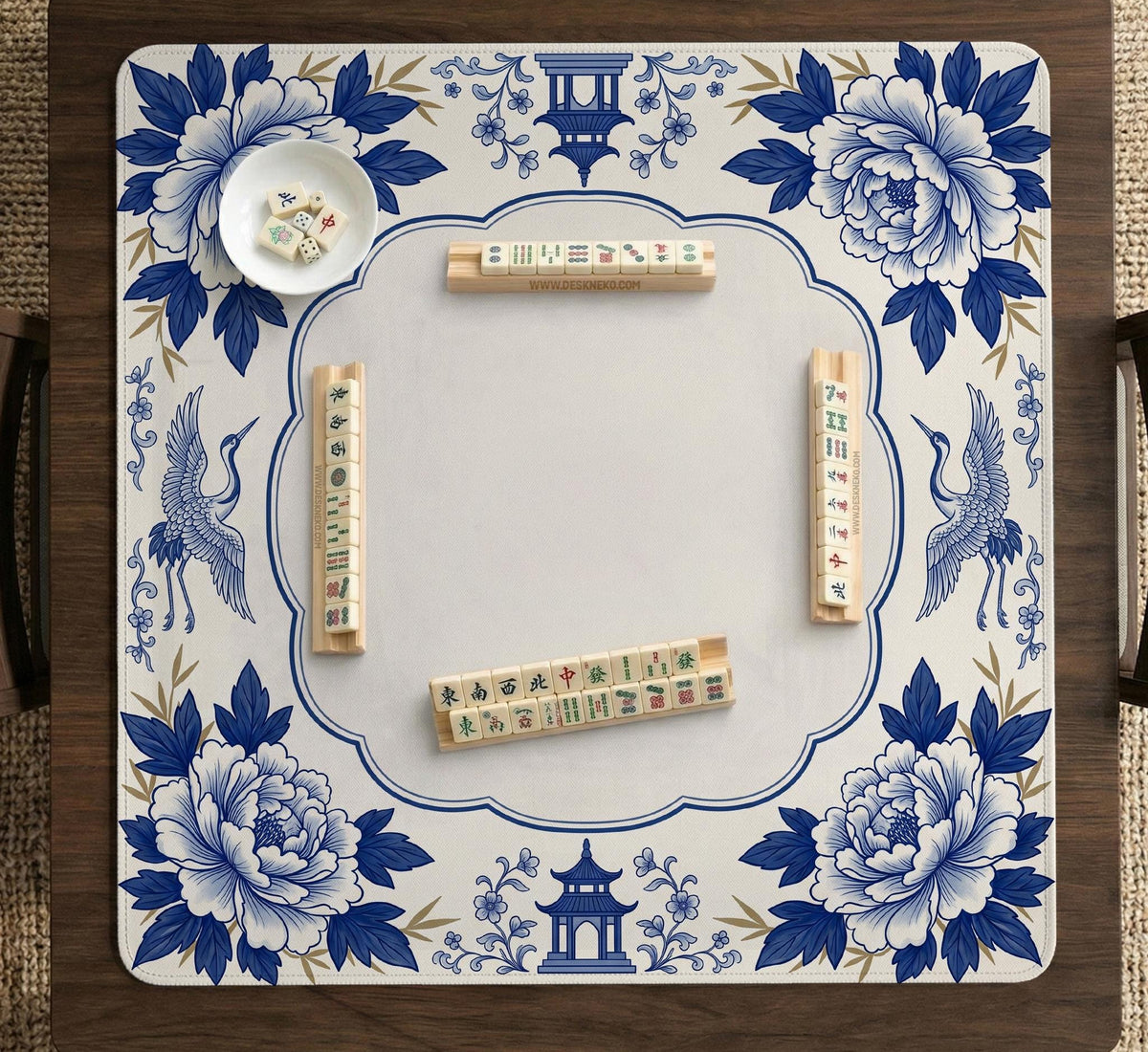 Blue and white mahjong mat with cranes, floral porcelain-style artwork, a cream center area, and a decorative border.