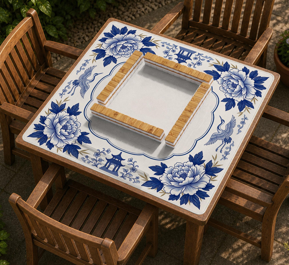 Blue and white mahjong mat with cranes, floral porcelain-style artwork, a cream center area, and a decorative border.