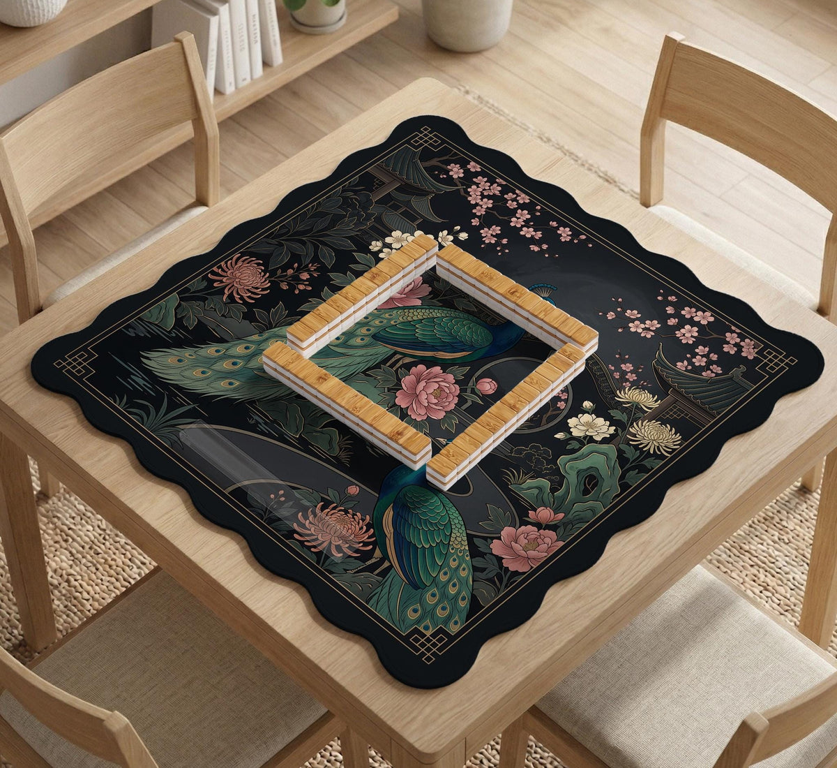 Square black mahjong mat with a gold peacock, blush flowers, and dark botanical artwork on a dark background.