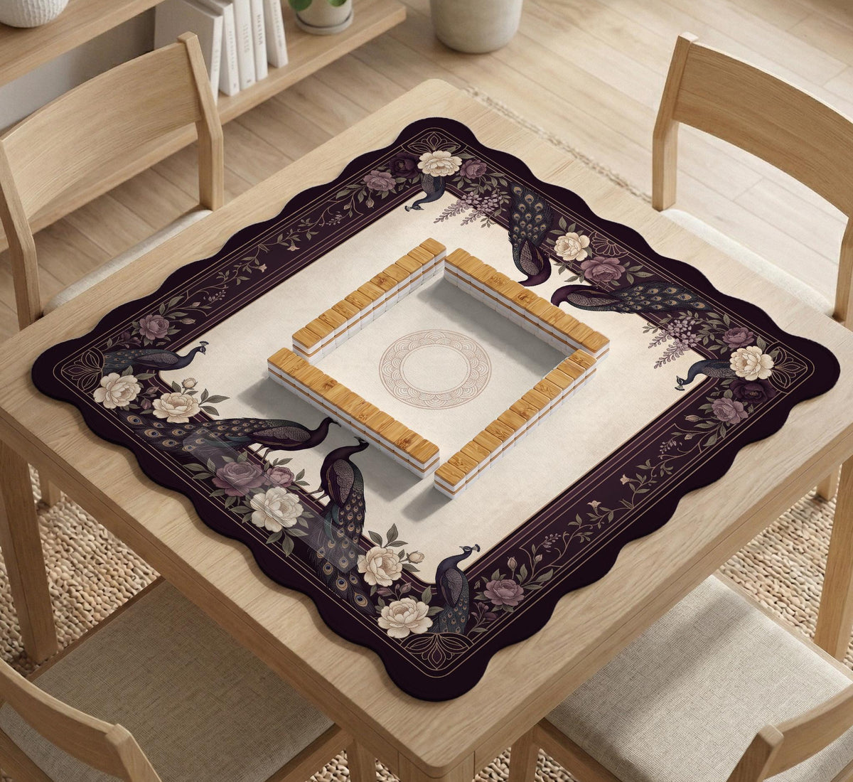 Square mahjong mat with a dark plum border, ivory floral pattern, muted sage leaves, and a decorative peacock garden design.