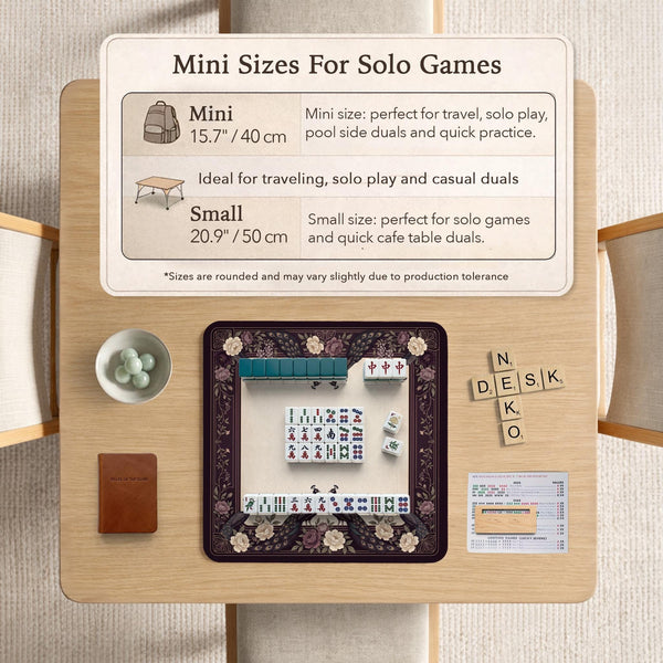 Square mahjong mat with a dark plum border, ivory floral pattern, muted sage leaves, and a decorative peacock garden design.