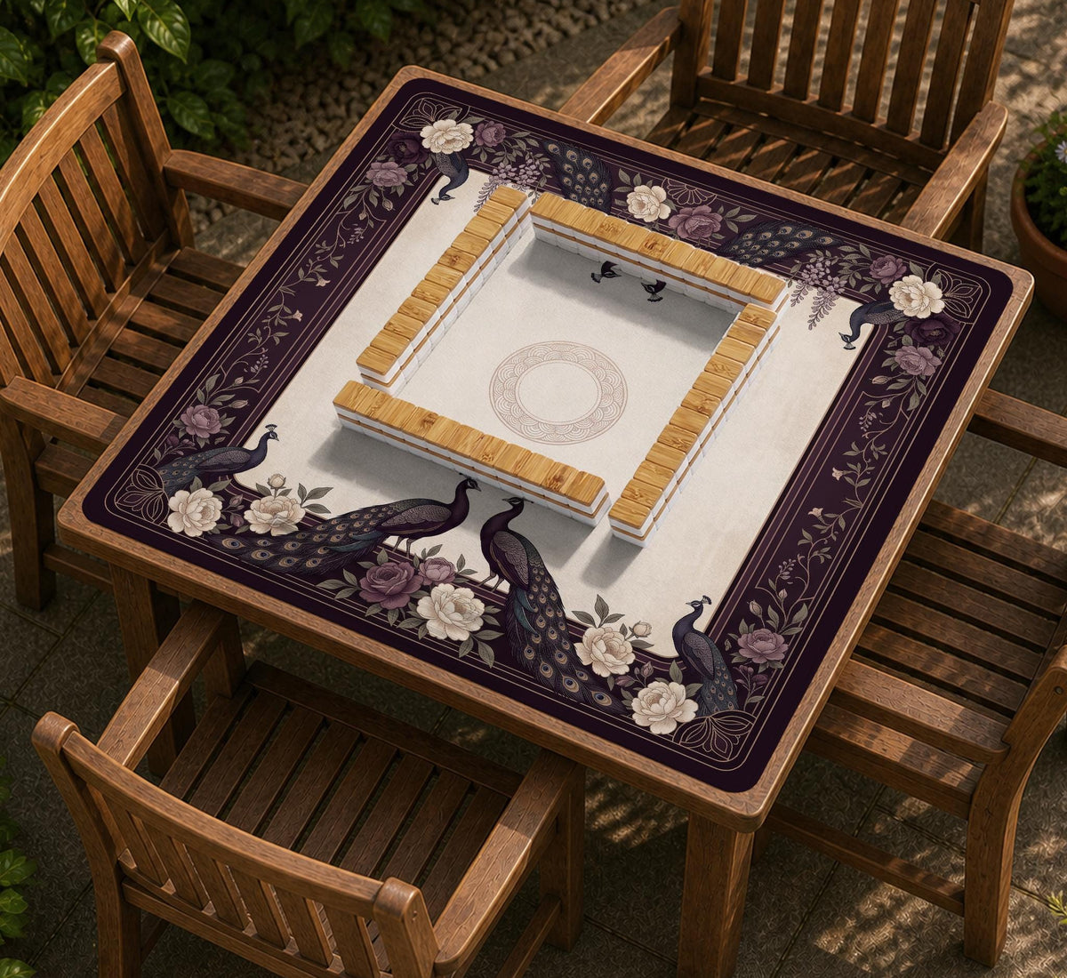 Square mahjong mat with a dark plum border, ivory floral pattern, muted sage leaves, and a decorative peacock garden design.