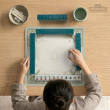 Square light green mahjong mat with bamboo stalks, soft ivory details, botanical shadows, mist lines, and a circular center design.