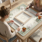 Square light green mahjong mat with bamboo stalks, soft ivory details, botanical shadows, mist lines, and a circular center design.