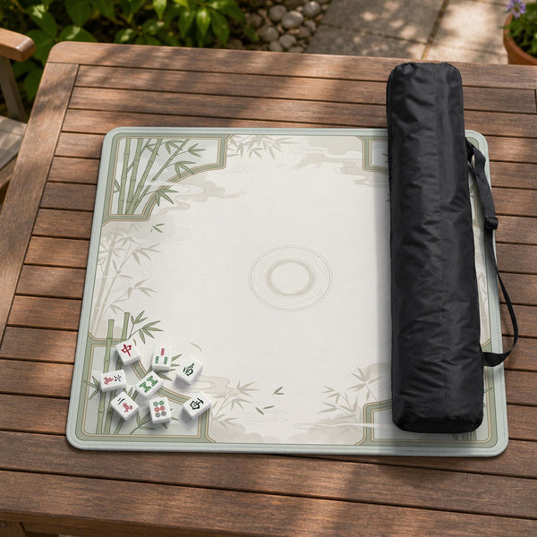 Square light green mahjong mat with bamboo stalks, soft ivory details, botanical shadows, mist lines, and a circular center design.