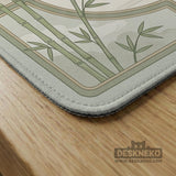 Square mahjong table mat with a pale cream center and green bamboo chinoiserie corners and border.