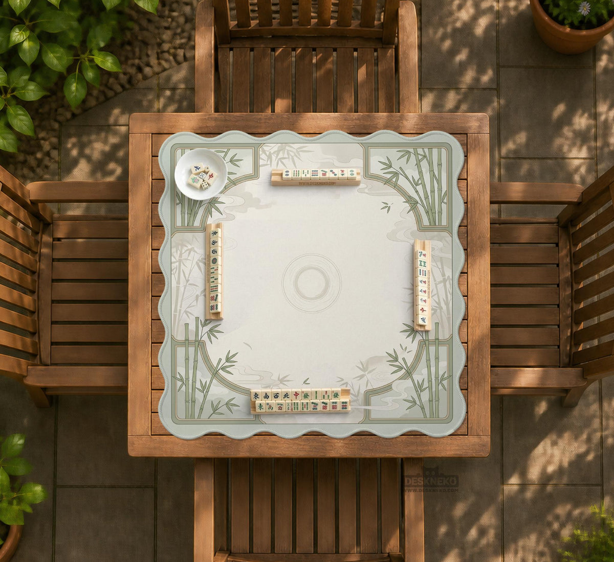 Square mahjong table mat with a pale cream center and green bamboo chinoiserie corners and border.