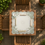 Square mahjong table mat with a pale cream center and green bamboo chinoiserie corners and border.