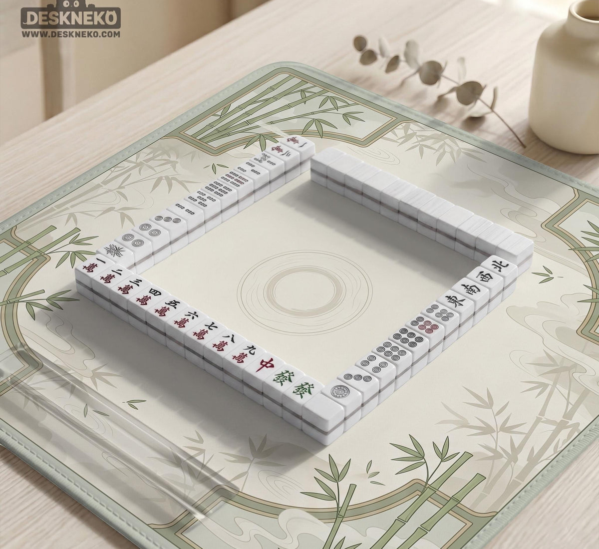 Square mahjong table mat with a pale cream center and green bamboo chinoiserie corners and border.