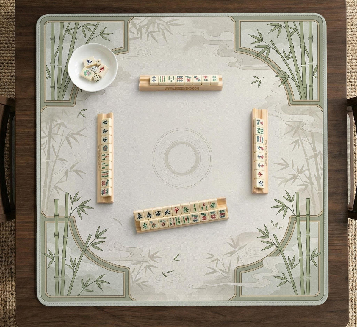Square mahjong table mat with a pale cream center and green bamboo chinoiserie corners and border.