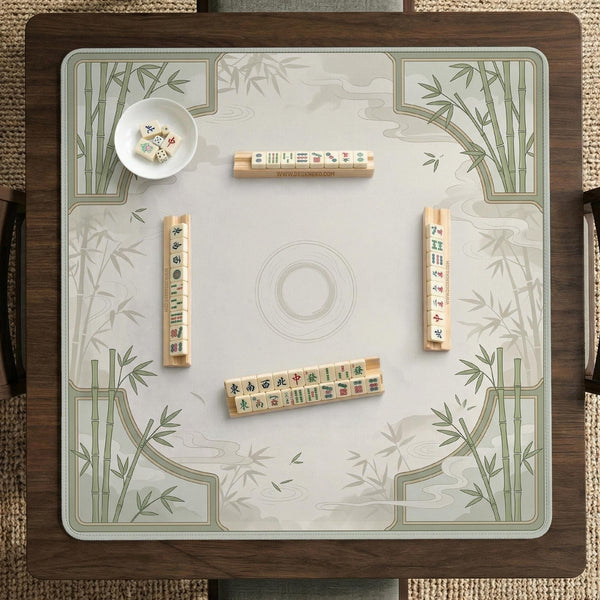 Square mahjong table mat with a pale cream center and green bamboo chinoiserie corners and border.