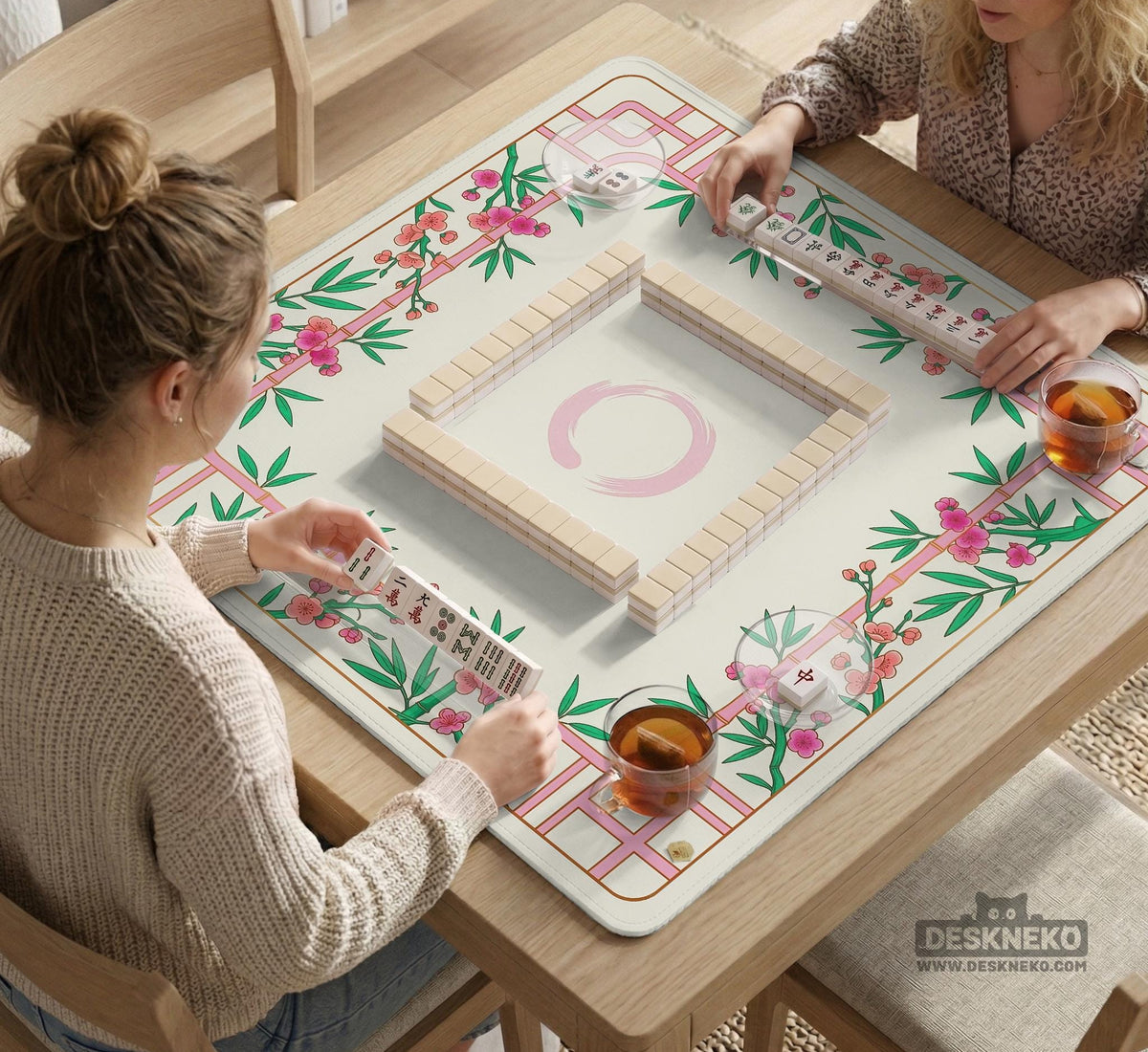 Pink cherry blossom floral mahjong table mat with a cream center and bamboo-style border design.