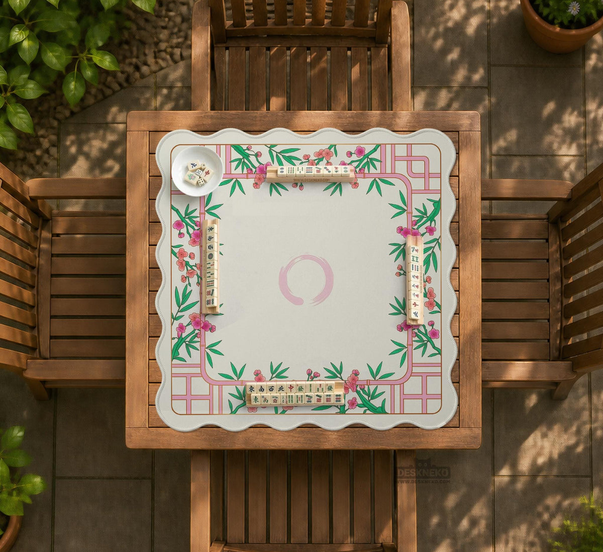 Pink cherry blossom floral mahjong table mat with a cream center and bamboo-style border design.
