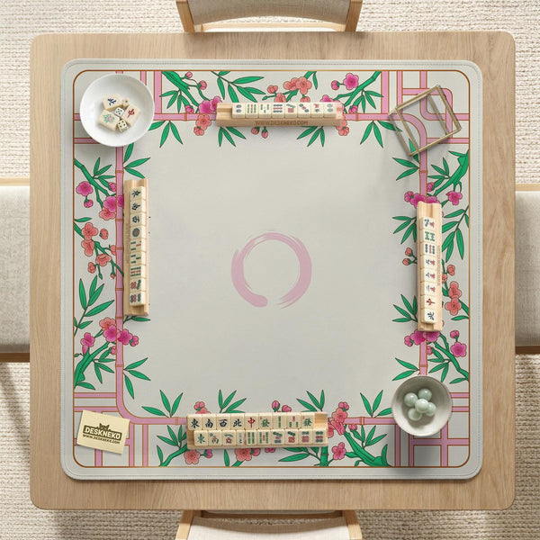 Pink cherry blossom floral mahjong table mat with a cream center and bamboo-style border design.