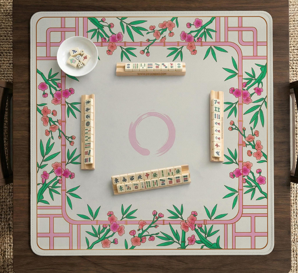 Pink cherry blossom floral mahjong table mat with a cream center and bamboo-style border design.