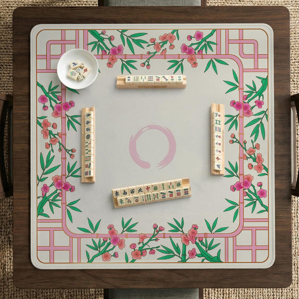 Pink cherry blossom floral mahjong table mat with a cream center and bamboo-style border design.
