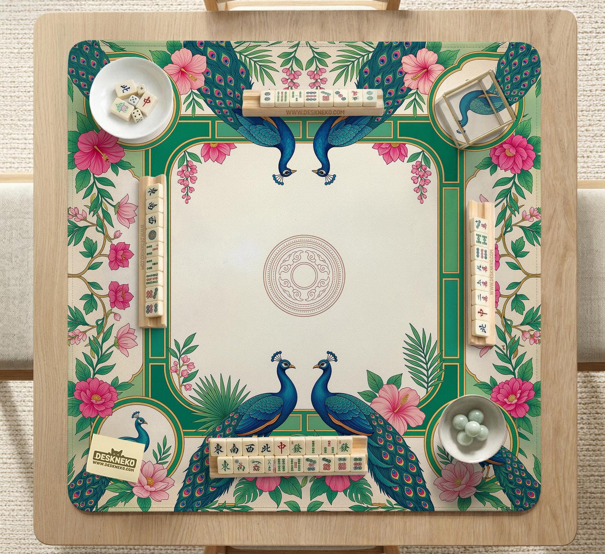 Green mahjong mat with peacocks, hibiscus flowers, tropical leaves, cream center space, and a scalloped floral border.