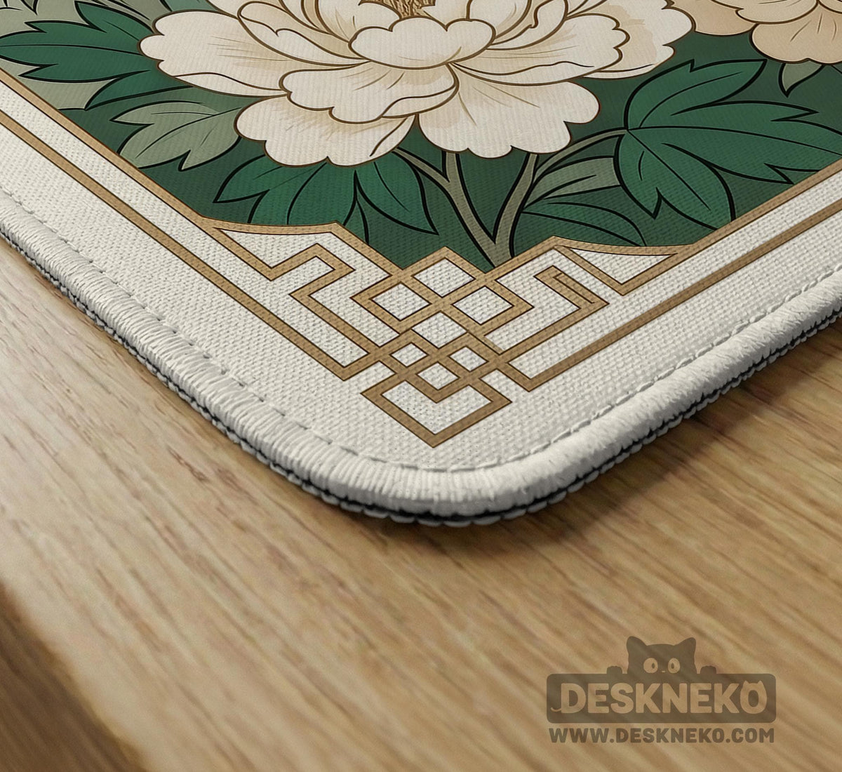 A green mahjong mat with peacock, floral, bamboo, pagoda, and gold border artwork in a scalloped chinoiserie style.