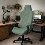 Sage green chair cover with a topographic line pattern shown on a desk chair, with armrest openings visible.