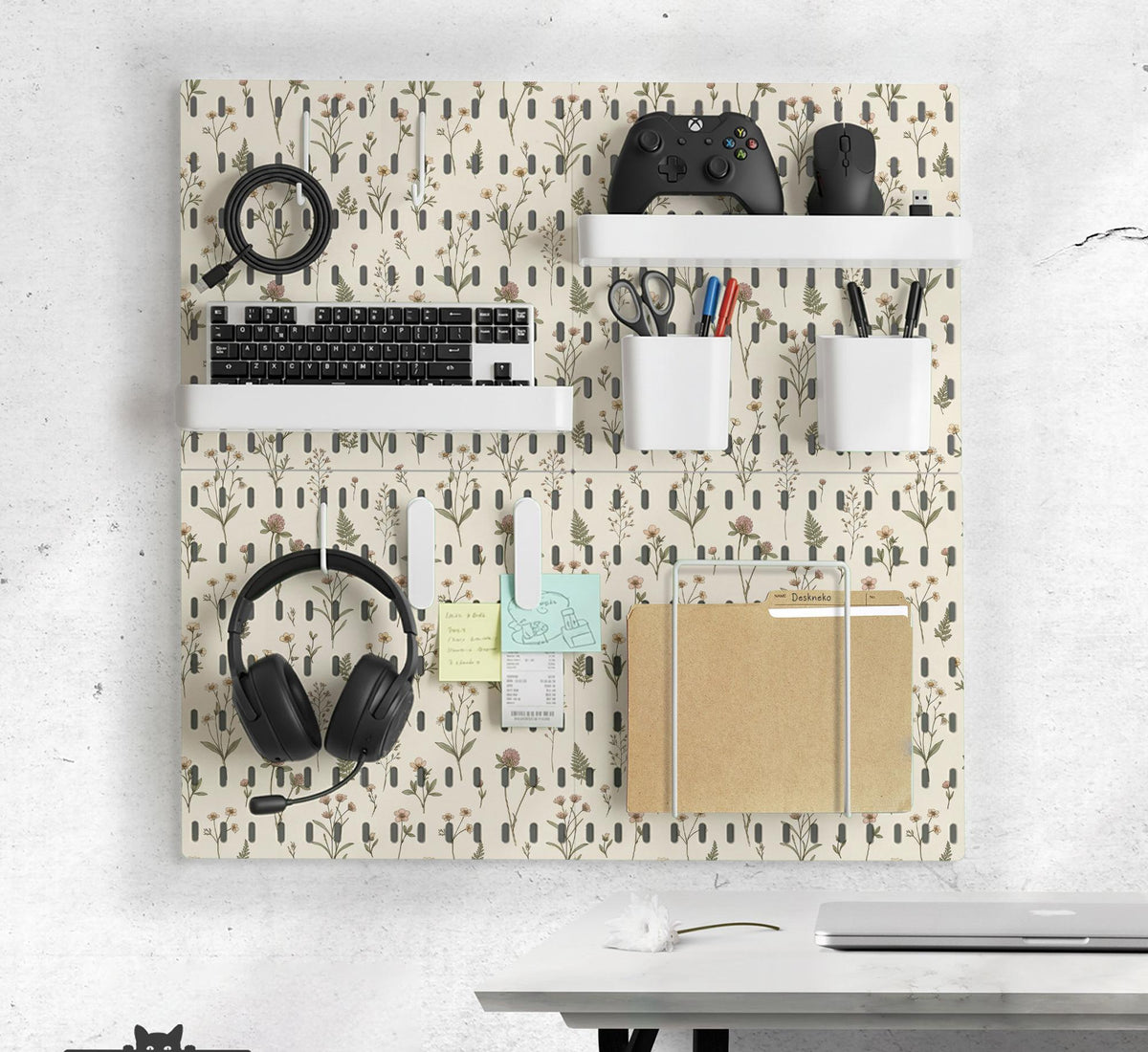 Cream pegboard wall organizer with small floral print, sage green stems, black slot layout, shelves, hooks, clips, and containers.