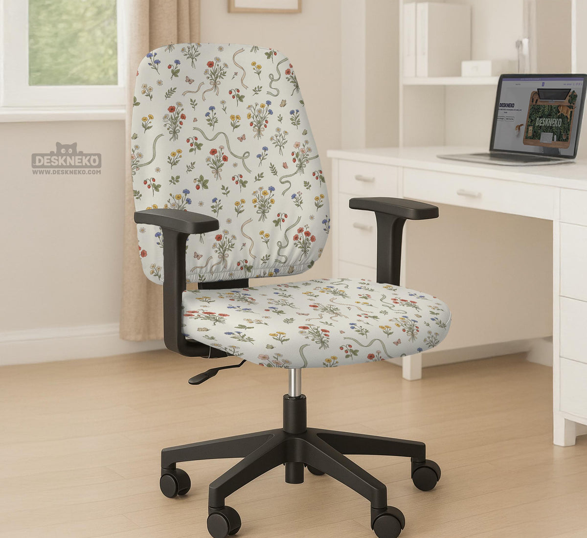 Cream chair cover with a scattered cottage garden floral print in red, blue, yellow, and green on a light background.